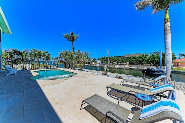 view of swimming pool with a patio, a water view, and a fenced in pool
