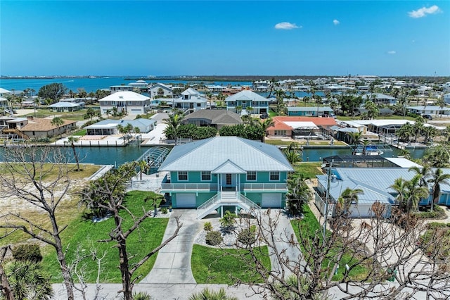 drone / aerial view featuring a residential view and a water view