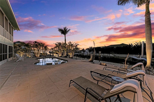 view of swimming pool featuring a patio, a boat dock, and a jacuzzi