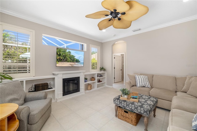 7804 Edmonston Cir, University Park, FL 34201 - living area featuring crown molding, visible vents, a glass covered fireplace, ceiling fan, and light tile patterned floors