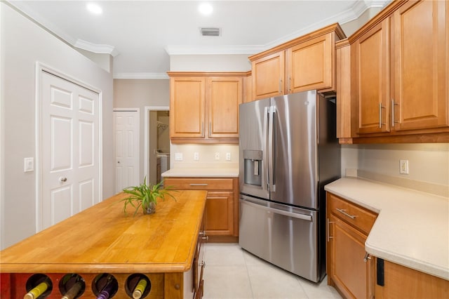 7804 Edmonston Cir, University Park, FL 34201 - kitchen with crown molding, light tile patterned flooring, stainless steel fridge with ice dispenser, wood counters, and visible vents
