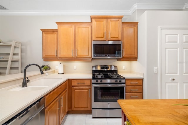 7804 Edmonston Cir, University Park, FL 34201 - kitchen featuring crown molding, appliances with stainless steel finishes, and a sink