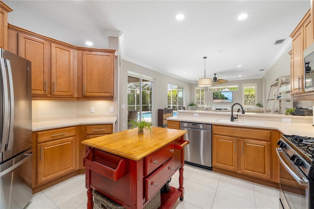 7804 Edmonston Cir, University Park, FL 34201 - kitchen with stainless steel appliances, visible vents, ornamental molding, and a sink