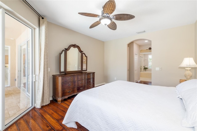 7804 Edmonston Cir, University Park, FL 34201 - bedroom featuring connected bathroom, ceiling fan, arched walkways, wood finished floors, and visible vents