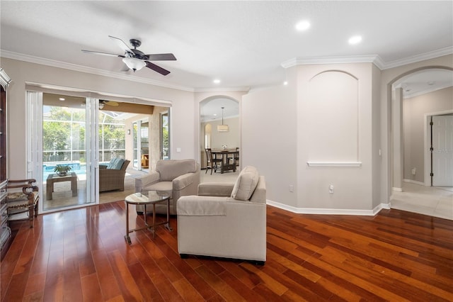 7804 Edmonston Cir, University Park, FL 34201 - living area featuring arched walkways, ceiling fan, ornamental molding, and wood finished floors