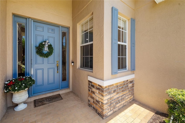 7804 Edmonston Cir, University Park, FL 34201 - property entrance with covered porch, brick siding, and stucco siding