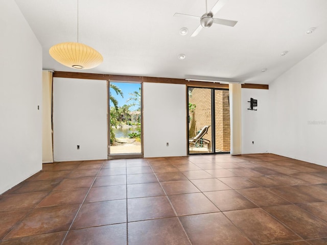 unfurnished room featuring floor to ceiling windows, a ceiling fan, and tile patterned flooring
