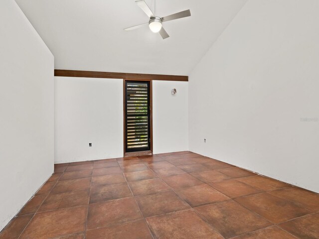 spare room with a ceiling fan and vaulted ceiling