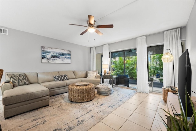 living room featuring a ceiling fan, visible vents, and light tile patterned floors