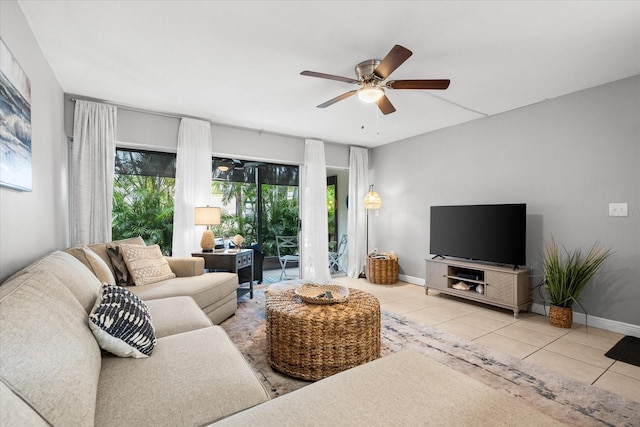 tiled living room featuring baseboards and a ceiling fan