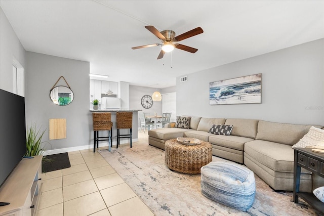 living area featuring visible vents, a ceiling fan, and light tile patterned flooring