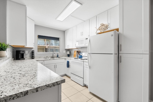 kitchen with a sink, white cabinets, white appliances, and light countertops