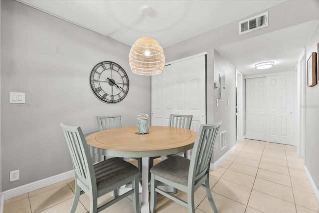 dining room featuring light tile patterned floors, baseboards, and visible vents