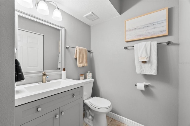 bathroom with visible vents, tile patterned flooring, vanity, toilet, and baseboards