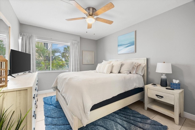 bedroom with baseboards, ceiling fan, and light tile patterned floors