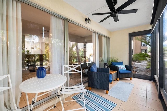 sunroom with a ceiling fan