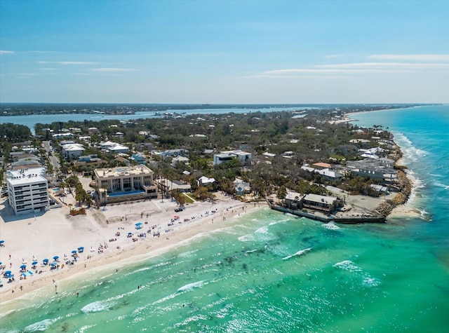 drone / aerial view featuring a beach view and a water view