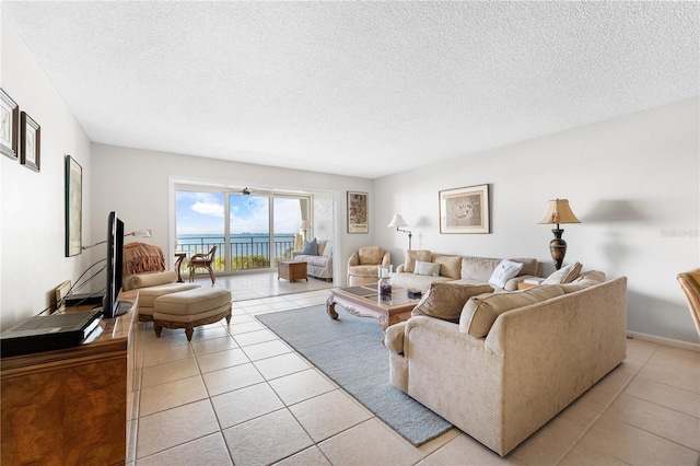 6460 Mourning Dove Dr Unit 102, Bradenton, FL 34210 - living area featuring a textured ceiling and light tile patterned flooring