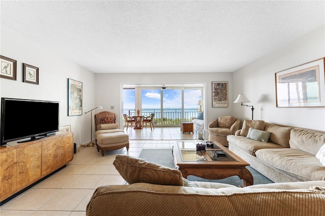 6460 Mourning Dove Dr Unit 102, Bradenton, FL 34210 - living room featuring light tile patterned flooring and a textured ceiling