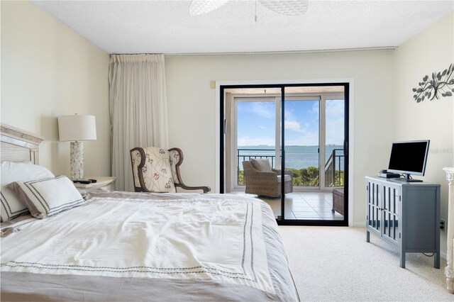 6460 Mourning Dove Dr Unit 102, Bradenton, FL 34210 - bedroom featuring access to outside, carpet flooring, and a textured ceiling