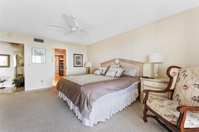 6460 Mourning Dove Dr Unit 102, Bradenton, FL 34210 - bedroom with light colored carpet, a spacious closet, baseboards, and a ceiling fan