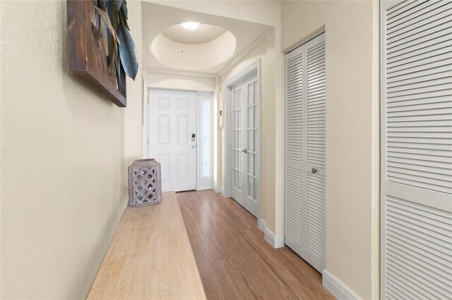 hall featuring wood finished floors and baseboards