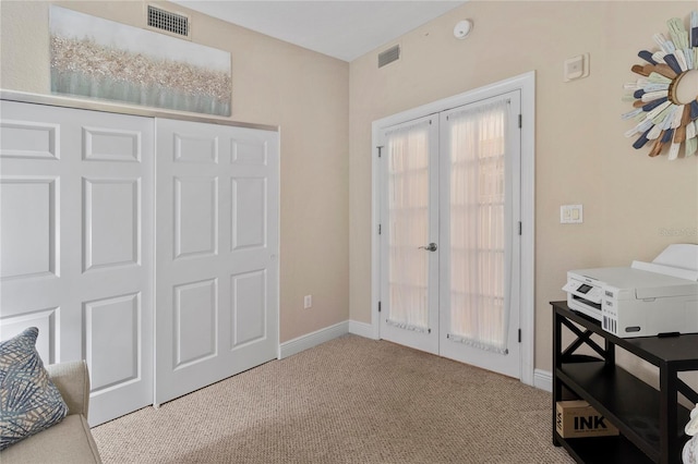 interior space with french doors, baseboards, visible vents, and carpet flooring