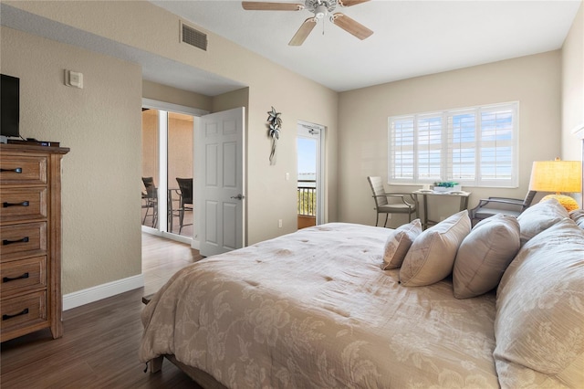 bedroom featuring baseboards, visible vents, wood finished floors, and ceiling fan