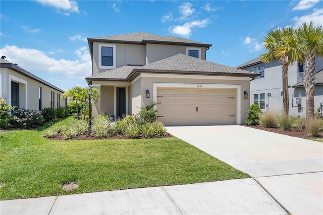 traditional home with roof with shingles, driveway, a garage, a front yard, and stucco siding