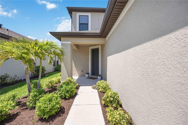 doorway to property with stucco siding