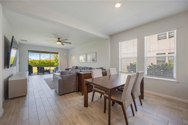 dining room with ceiling fan, baseboards, light wood-style floors, and visible vents