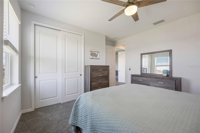 bedroom with carpet flooring, multiple windows, visible vents, and a closet