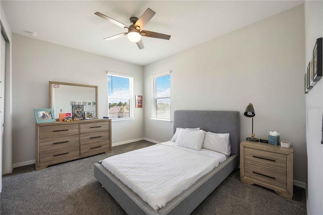 bedroom with dark colored carpet, a ceiling fan, and baseboards
