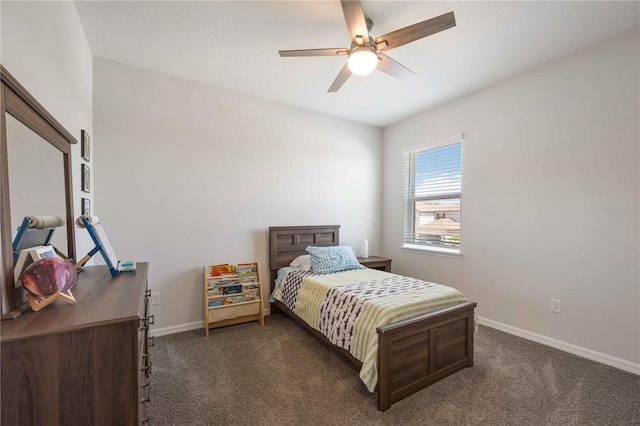 bedroom with baseboards, dark carpet, and ceiling fan