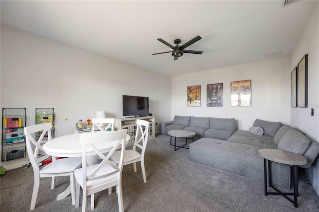 carpeted living room with visible vents and ceiling fan
