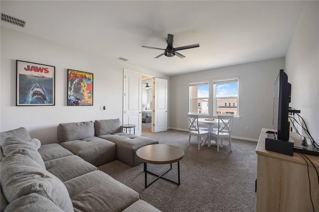 living area with carpet, visible vents, a ceiling fan, and baseboards