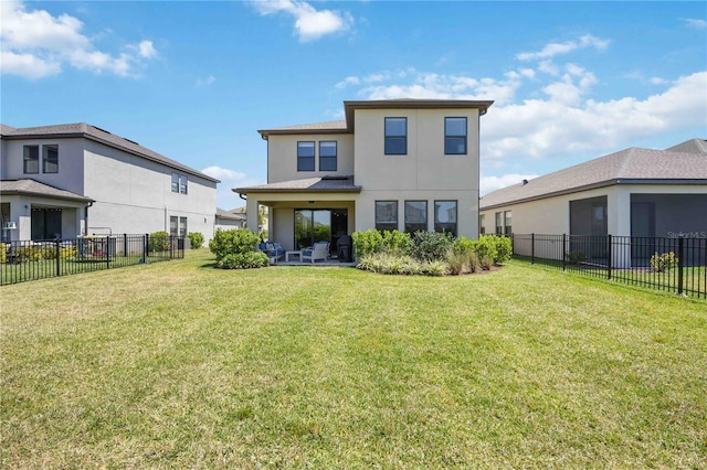 back of property with a lawn, a fenced backyard, and stucco siding