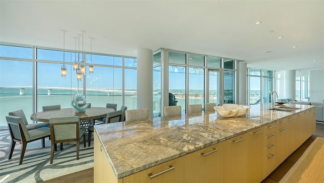 280 Golden Gate Pt Unit 600, Sarasota, FL 34236 - sunroom featuring a water view and a sink