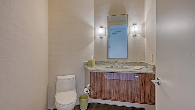 280 Golden Gate Pt Unit 600, Sarasota, FL 34236 - bathroom with toilet, vanity, and wood finished floors