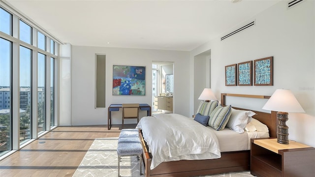 280 Golden Gate Pt Unit 600, Sarasota, FL 34236 - bedroom featuring multiple windows, visible vents, and wood finished floors