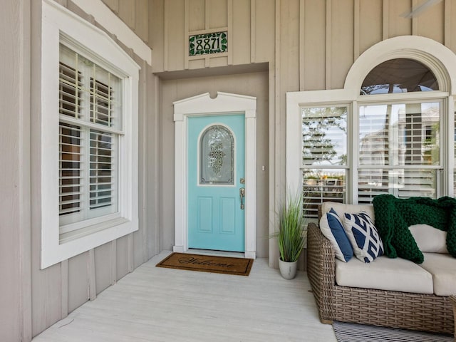 8871 Fishermens Bay Dr, Sarasota, FL 34231 - entrance to property featuring covered porch and board and batten siding
