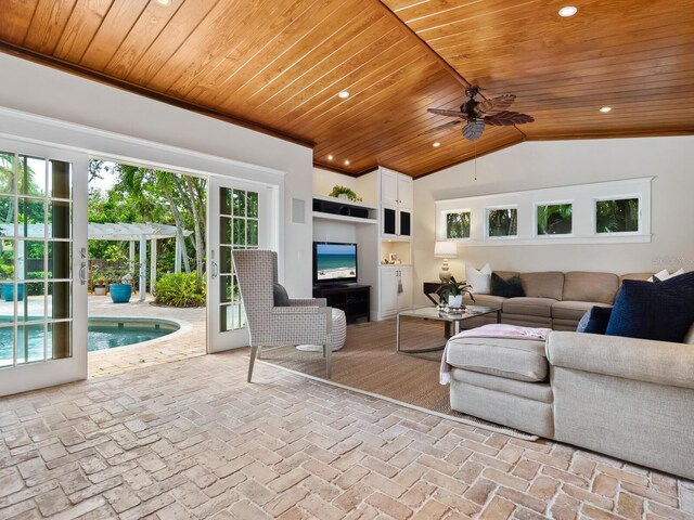 8871 Fishermens Bay Dr, Sarasota, FL 34231 - living room featuring wood ceiling, recessed lighting, vaulted ceiling, a ceiling fan, and brick floor
