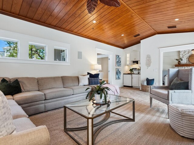 8871 Fishermens Bay Dr, Sarasota, FL 34231 - living room featuring wooden ceiling, lofted ceiling, crown molding, visible vents, and light colored carpet