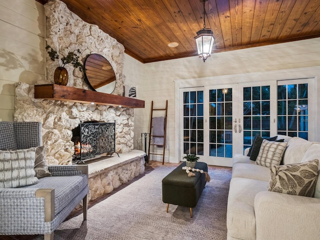8871 Fishermens Bay Dr, Sarasota, FL 34231 - living area featuring wooden ceiling, ornamental molding, a fireplace, carpet flooring, and french doors
