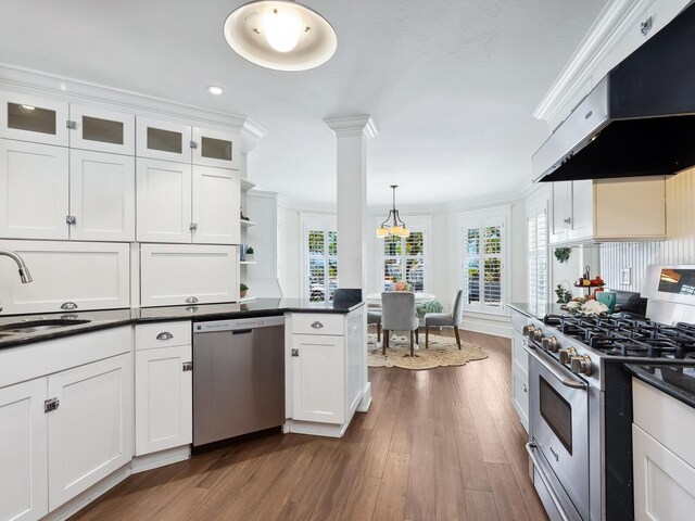 8871 Fishermens Bay Dr, Sarasota, FL 34231 - kitchen with dark countertops, a sink, appliances with stainless steel finishes, and under cabinet range hood