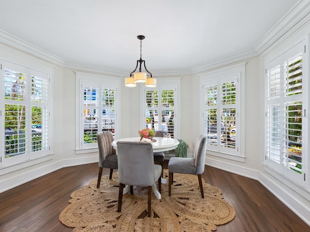 8871 Fishermens Bay Dr, Sarasota, FL 34231 - dining area featuring crown molding, an inviting chandelier, dark wood-style flooring, and baseboards