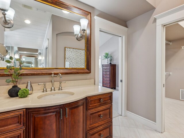 8871 Fishermens Bay Dr, Sarasota, FL 34231 - bathroom with visible vents, vanity, and tile patterned flooring