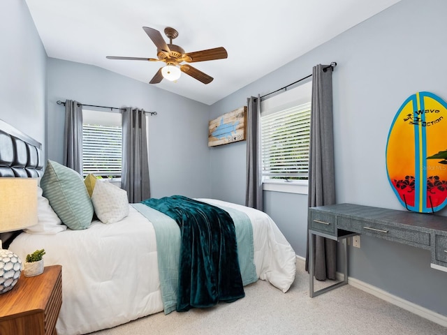 8871 Fishermens Bay Dr, Sarasota, FL 34231 - carpeted bedroom with lofted ceiling, ceiling fan, baseboards, and multiple windows