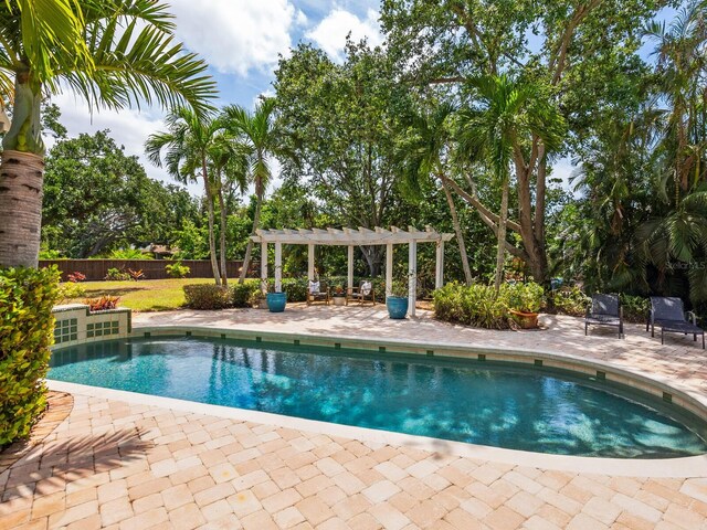 8871 Fishermens Bay Dr, Sarasota, FL 34231 - pool featuring a pergola, a patio, and a fenced backyard