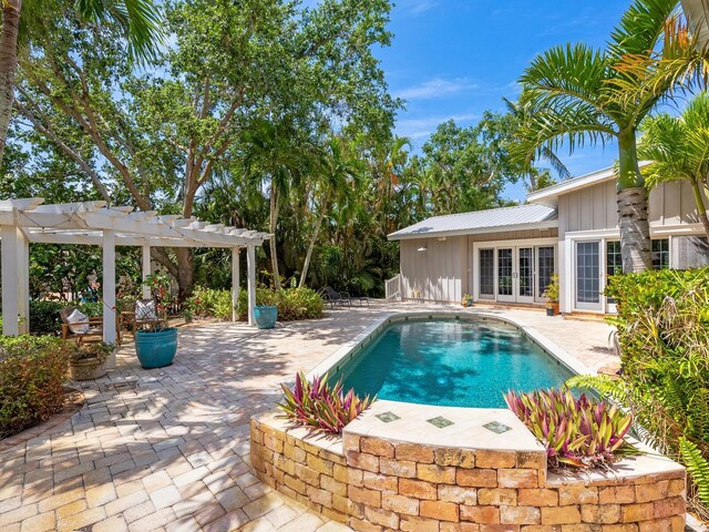 8871 Fishermens Bay Dr, Sarasota, FL 34231 - outdoor pool featuring a pergola, french doors, and a patio area